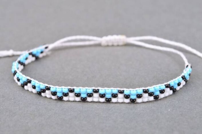 A bracelet made of thread and beads is a talisman that will bring good luck to the owner